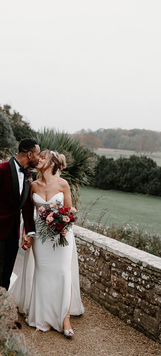 winter wedding at Berkeley Castle with red wedding suit jacket