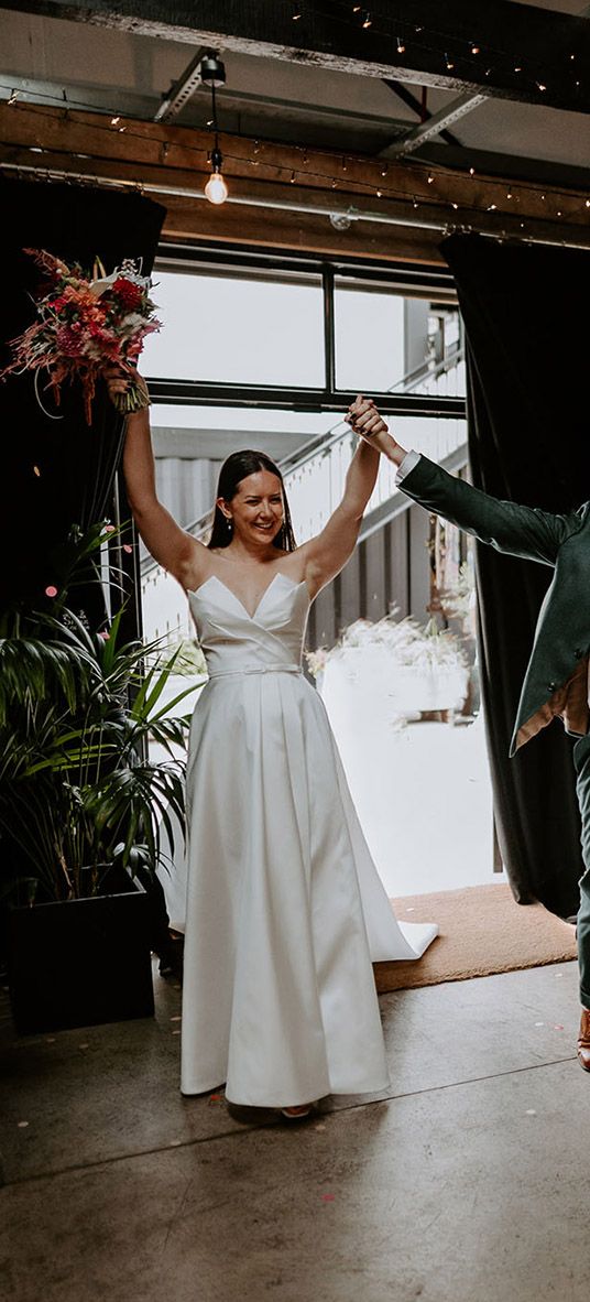 Bride and groom enter their wedding reception 