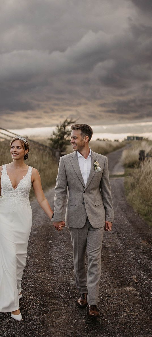 Elmley Nature Reserve wedding with bride and groom walking together