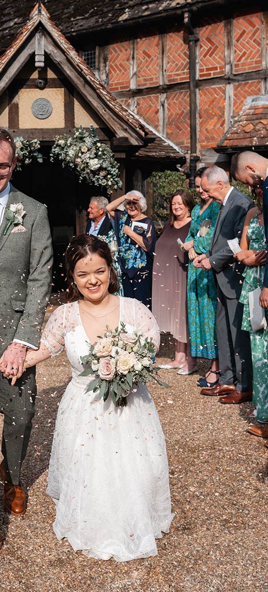 bride and groom have confetti exit at Langshott Manor in Surrey
