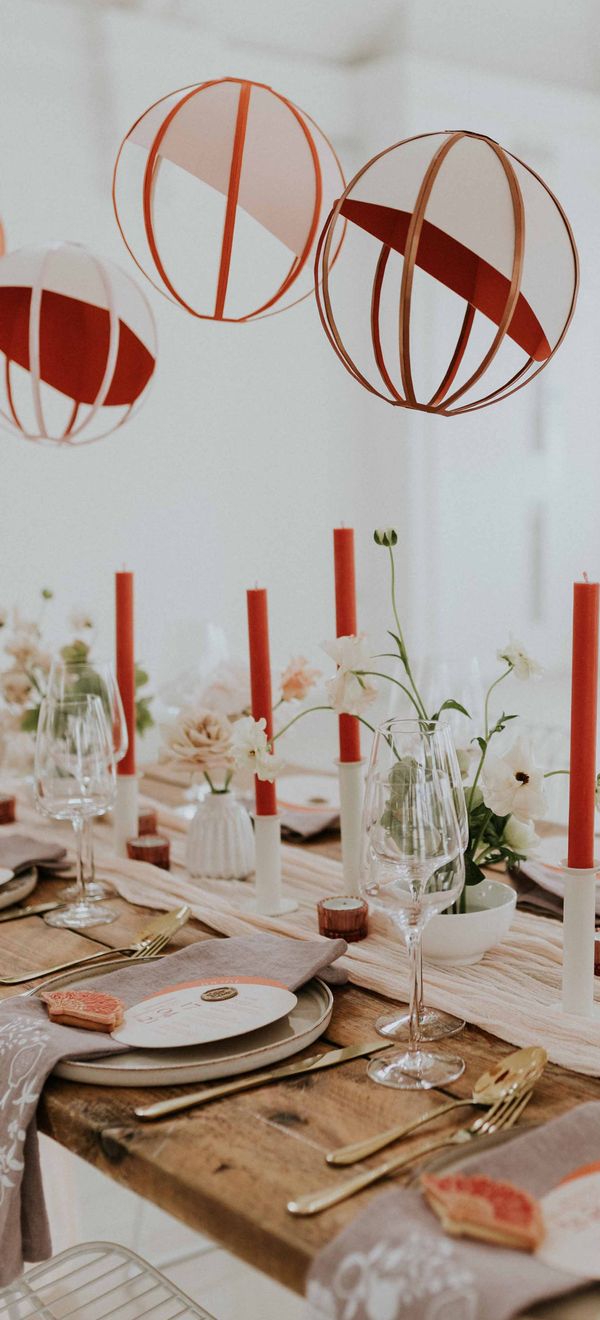 Modern Asian wedding decor ideas with orange and gold colour scheme, lanterns and embroidered napkins