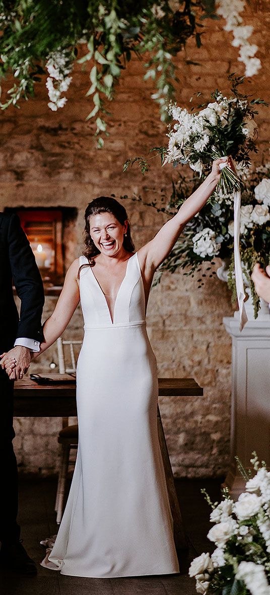 bride and groom exit form their ceremony at their barn wedding