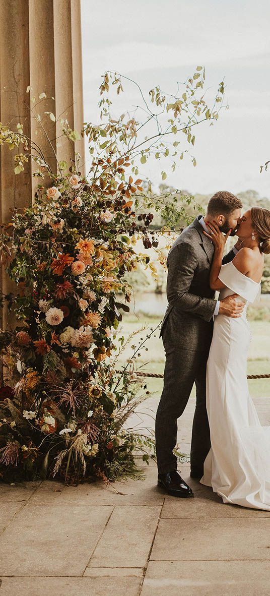 Boho autumnal wedding column flower arrangements.