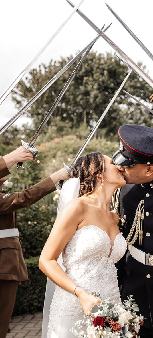 The arch of sabres at multicultural wedding at The Old Kent Barn and The Langham in London