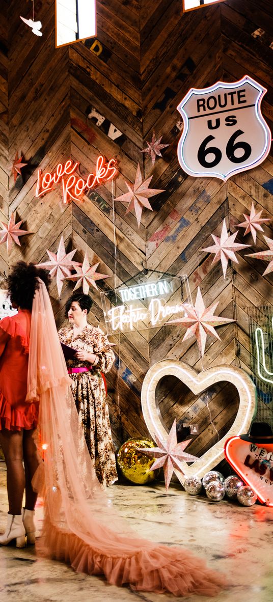 Fun Neon wedding inspiration at The Canary Shed in Essex with Red wedding dress, and colourful flowers 