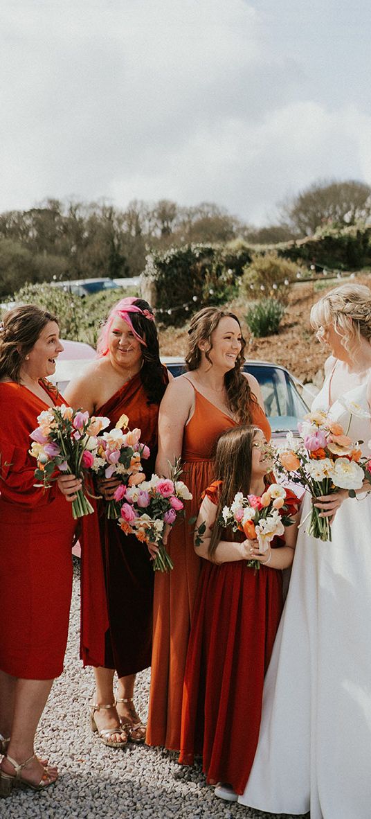 Tregedna Lodge wedding with bridesmaids in orange bridesmaid dresses.