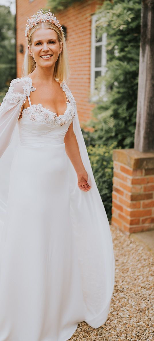 Bride in a handmade wedding dress, bridal cape and crown.