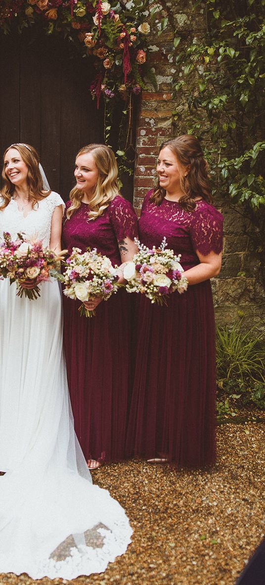 Ramster Hall wedding with bride and bridesmaids in dark red dresses