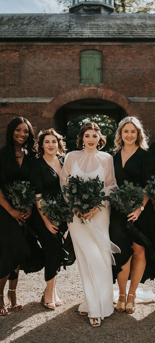 Bride and bridesmaids all holding preserved flower bouquets.