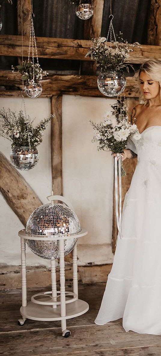 bride at disco wedding with disco ball decor