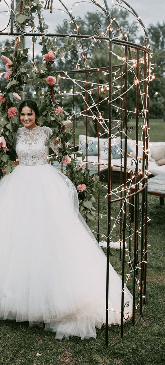 Tulle skirt princess wedding dress with long sleeves and lace detail