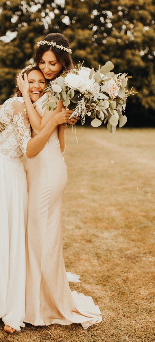 Bride and bridesmaid embracing as you can see the friendship between them