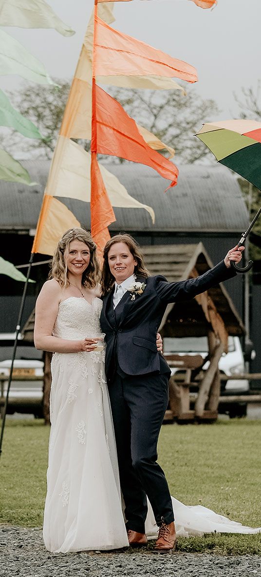 LGBTQIA+ Stanford Farm Pride wedding with rainbow festival flags, fairy lights and foliage weddng decor by The Bearded Man Photography