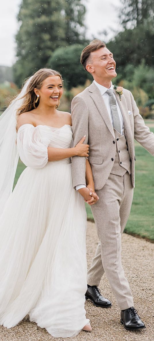 Bride in whimsical wedding dress with the groom for country house wedding.