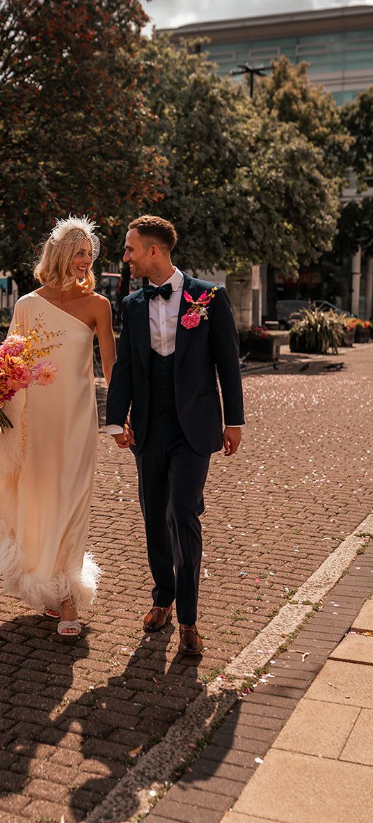 bride-in-cold-shoulder-feather-wedding-dress-with-groom-at-hackney-wedding