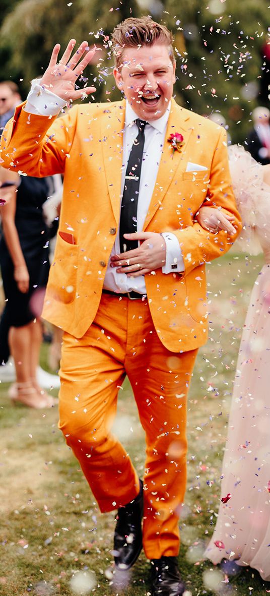 confetti moment at preston court wedding with pink wedding dress and yellow wedding suit