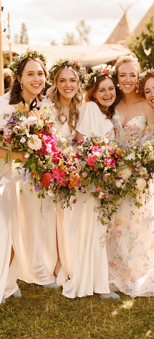 bridesmaids-wearing-ivory-dresses-with-flower-crowns-at-garden-wedding