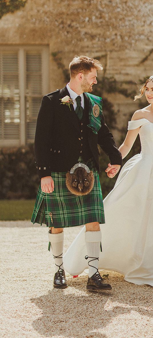 groom-in-green-kilt-with-bride-in-corset-off-the-shoulder-wedding-dress-at-luxe-country-house-wedding