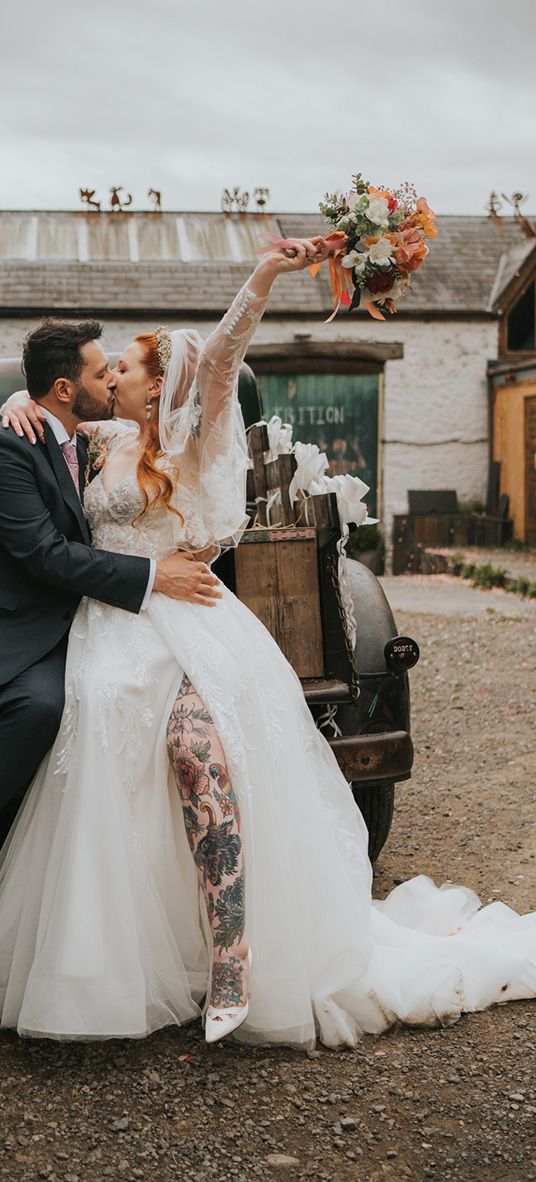 bride-and-groom-kiss-in-front-of-wedding-car-at-welsh-wedding