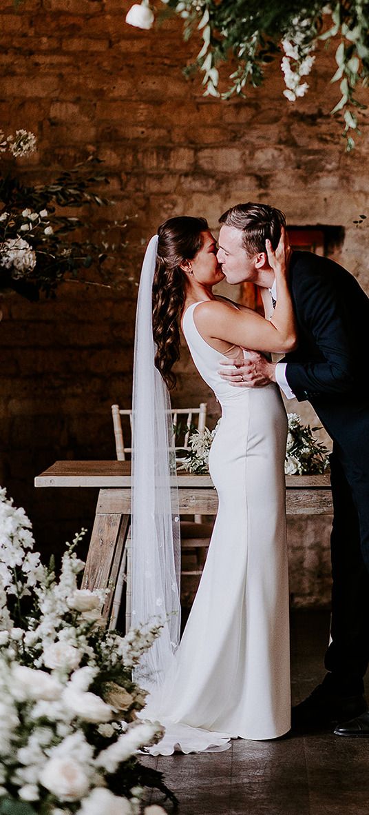 bride-and-groom-have-first-kiss-best-wedding-dates-2025