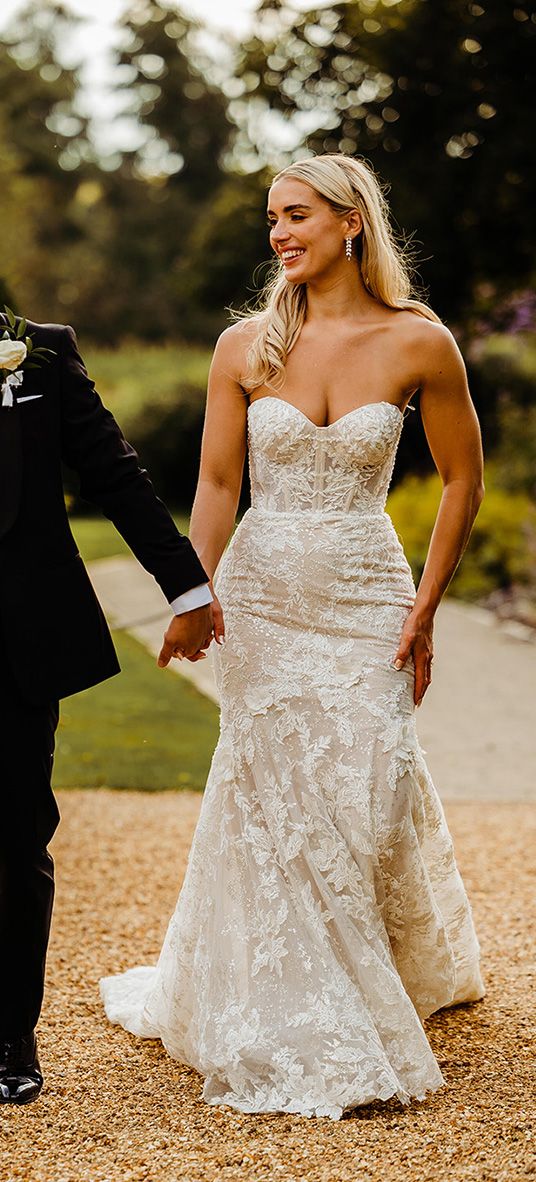 bride-wearing-lace-wedding-dress-with-groom-in-black-tuxedo-for-traditional-wedding