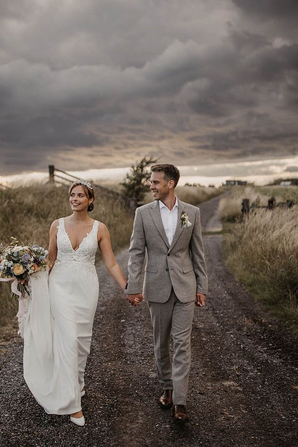 Elmley Nature Reserve wedding with bride and groom walking together
