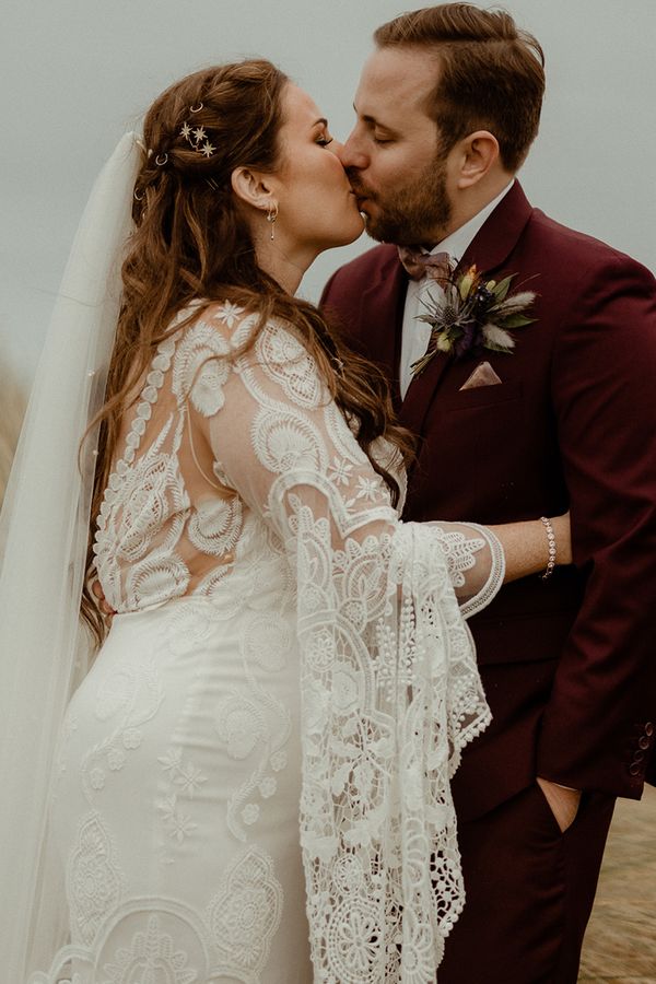Boho Newton Hall wedding with the bride in a lace wedding dress.