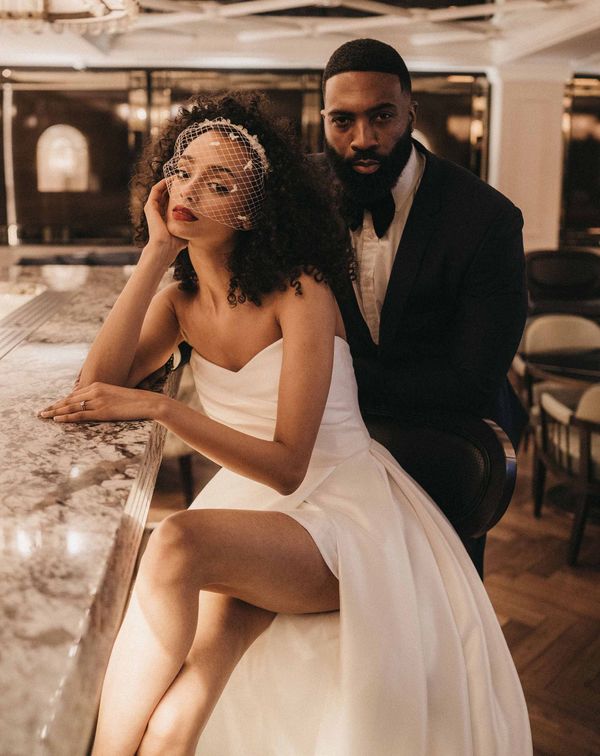 Stylish Mayfair Townhouse wedding inspiration with front slit wedding dress, birdcage veil and velvet suit jacket