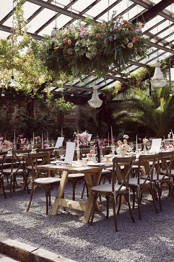 Anran wedding venue with hanging flower installations and chandeliers.