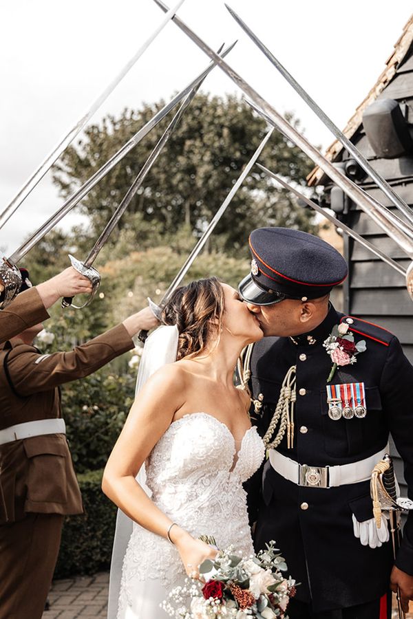 The arch of sabres at multicultural wedding at The Old Kent Barn and The Langham in London