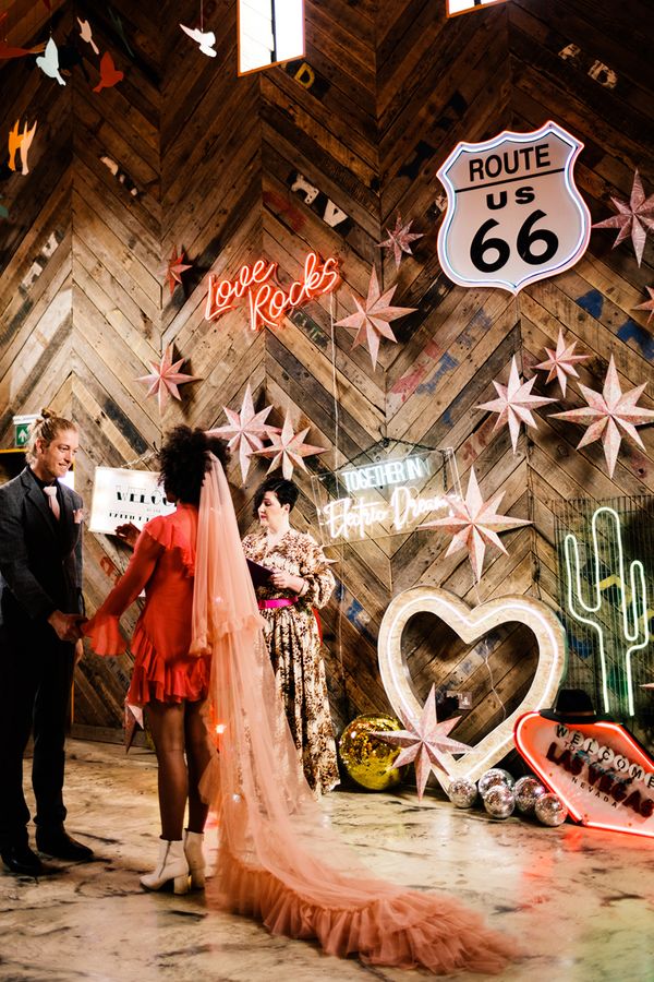 Fun Neon wedding inspiration at The Canary Shed in Essex with Red wedding dress, and colourful flowers 