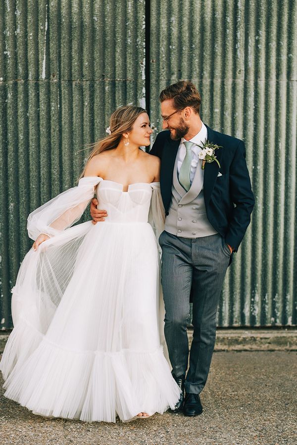Bride in tulle wedding dress by Alena Leena Bridal with groom. 