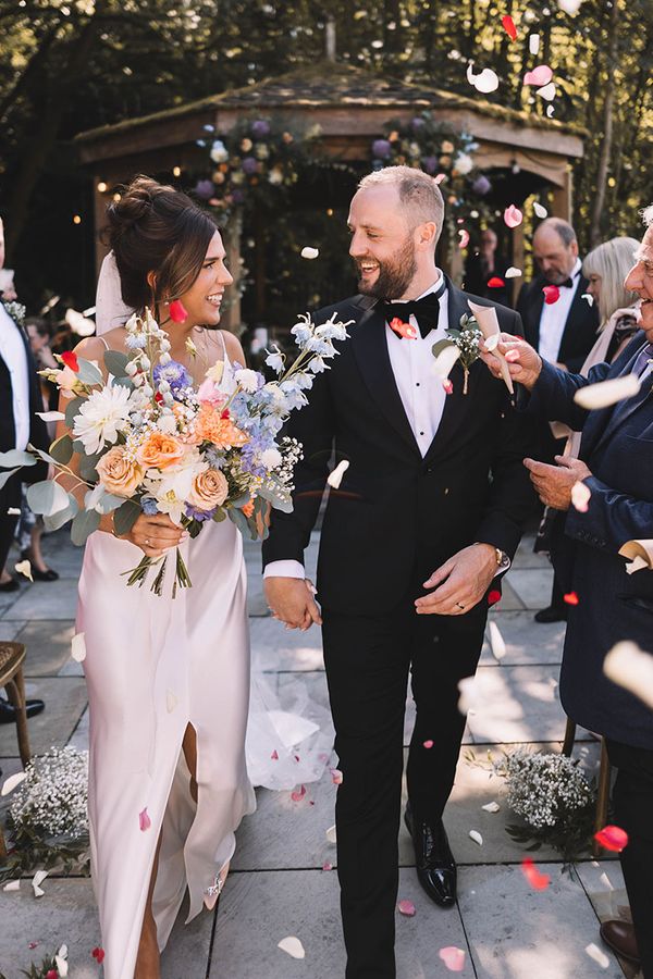 Confetti exit from Bowers Mill outdoor wedding ceremony with pastel wedding theme 
