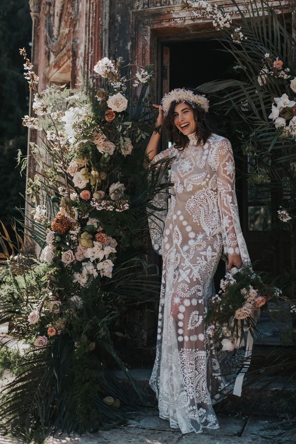 Boho destination Larmer Tree wedding inspiration with palms, muted florals and a lace wedding dress
