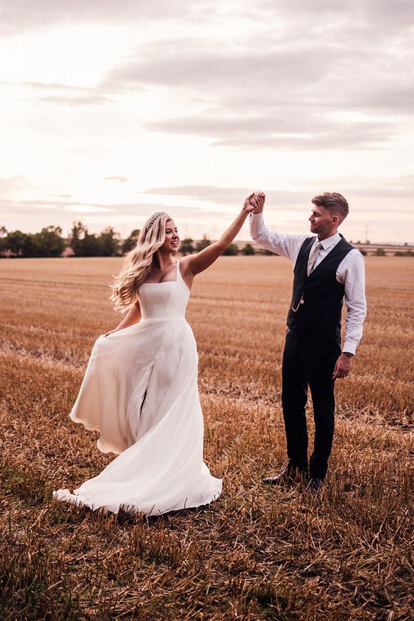 groom-spins-bride-around-for-wedding-photos