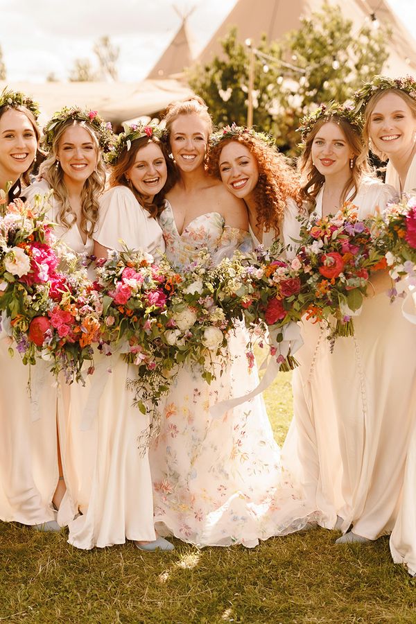 bridesmaids-wearing-ivory-dresses-with-flower-crowns-at-garden-wedding