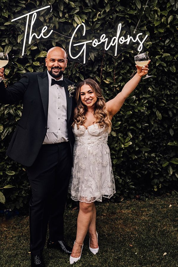 gin-bar-for-at-home-marquee-wedding-with-personalised-neon-sign-and-short-wedding-dress