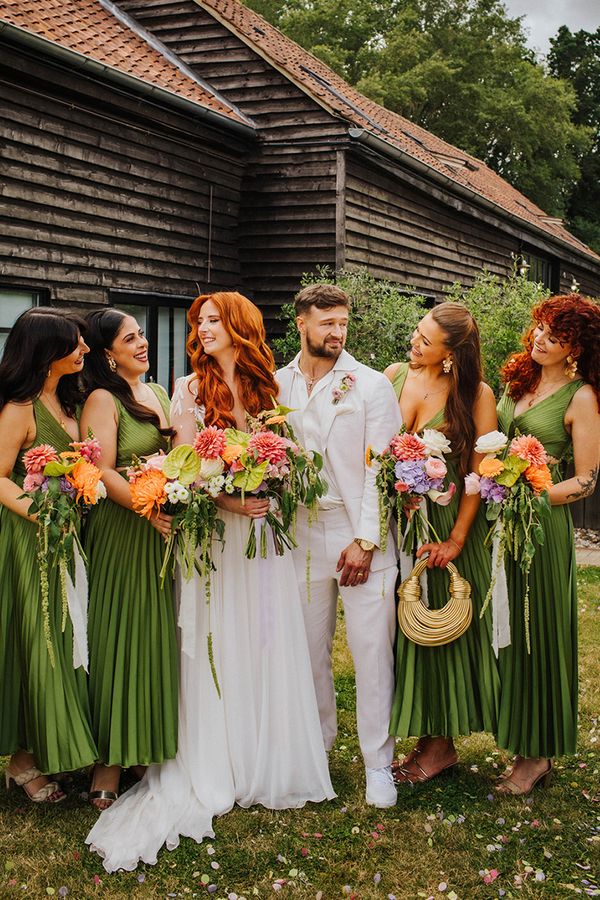 bridal-party-wearing-dark-green-pleated-bridesmaid-dresses