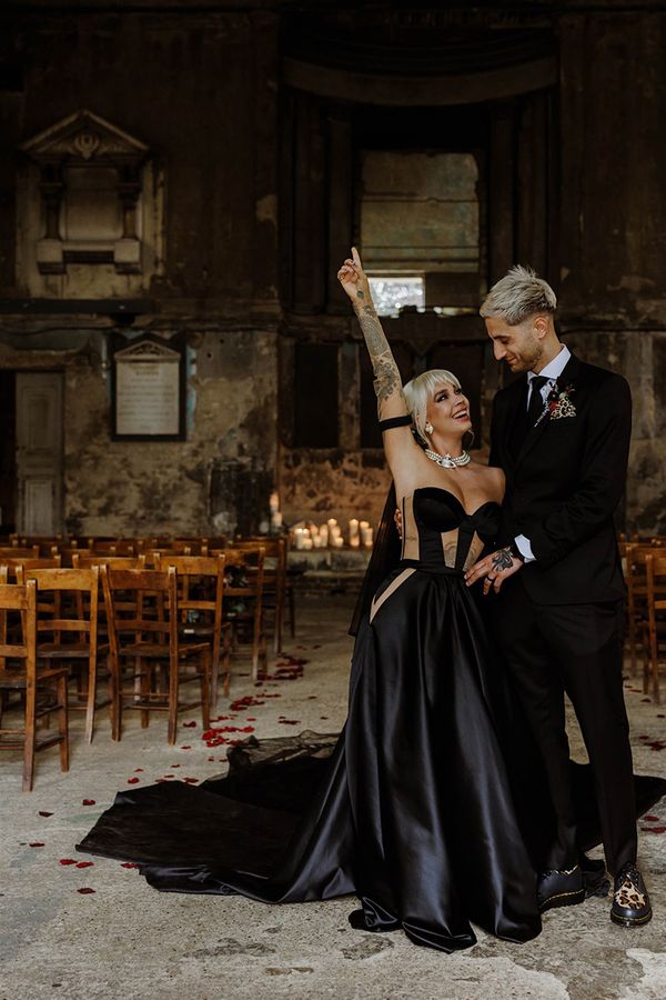 bride-wearing-custom-black-wedding-dress-with-groom-at-gothic-wedding