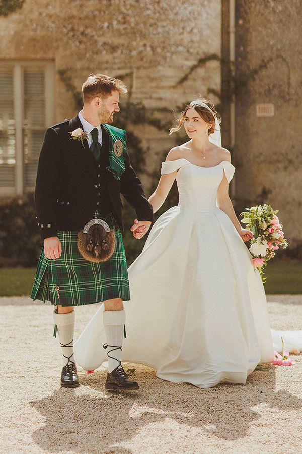 groom-in-green-kilt-with-bride-in-corset-off-the-shoulder-wedding-dress-at-luxe-country-house-wedding