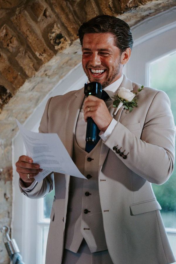 Groom in Three Piece Light Grey Wedding Suit Reading Out Wedding Speech