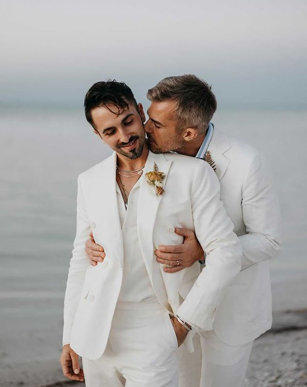 two grooms embracing at LGBT friendly mexico destination wedding