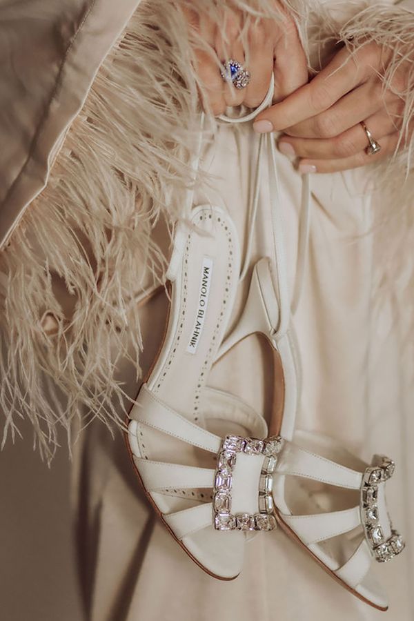 Sparkly buckle on white Manolo Blahnik designer wedding shoes for bride
