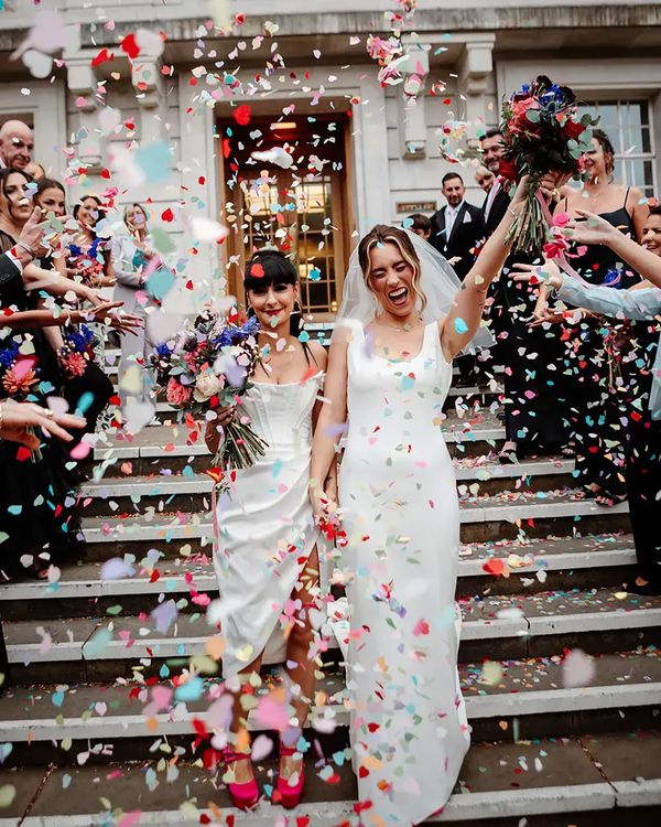 Colourful confetti exit on steps at town hall wedding