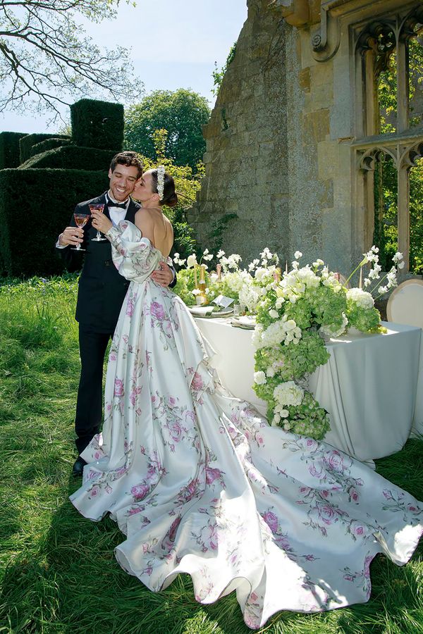 White spring wedding dress with train and pink floral pattern