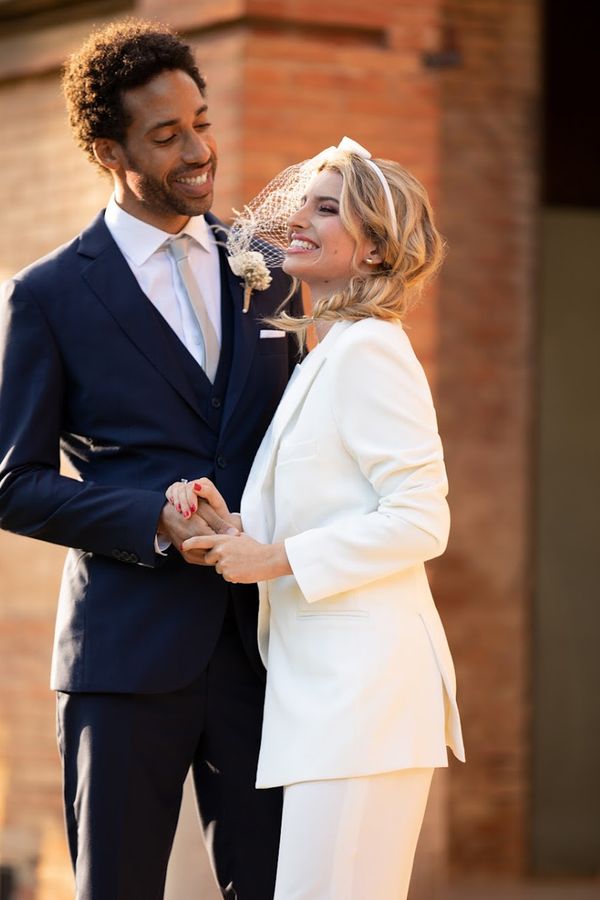 Couple wearing Hockerty and Sumissura custom bride and groom wedding suits