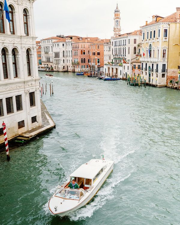 White wedding boat travelling through Venice grand canal