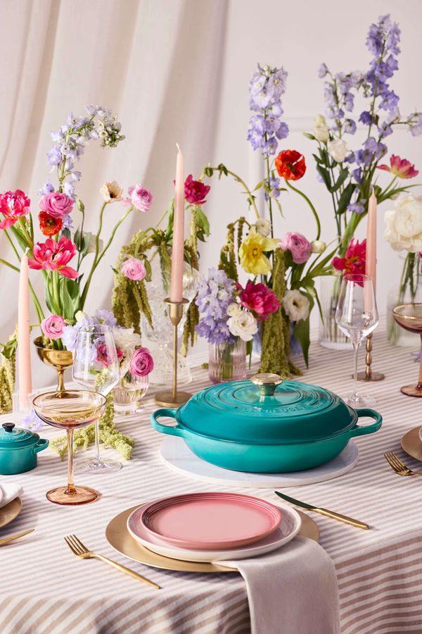 Le Creuset Bleu Riviera new cast iron casserole dish styled on a colourful wedding tablescape with pastel florals, glassware and modern table decor