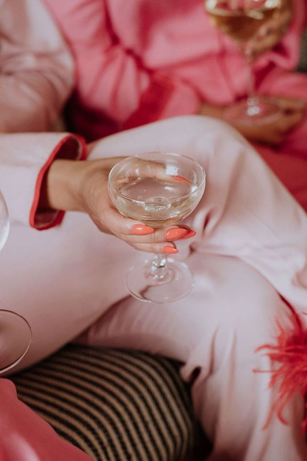 Galentine's theme ideas with groups of friends in pink feather pyjamas 