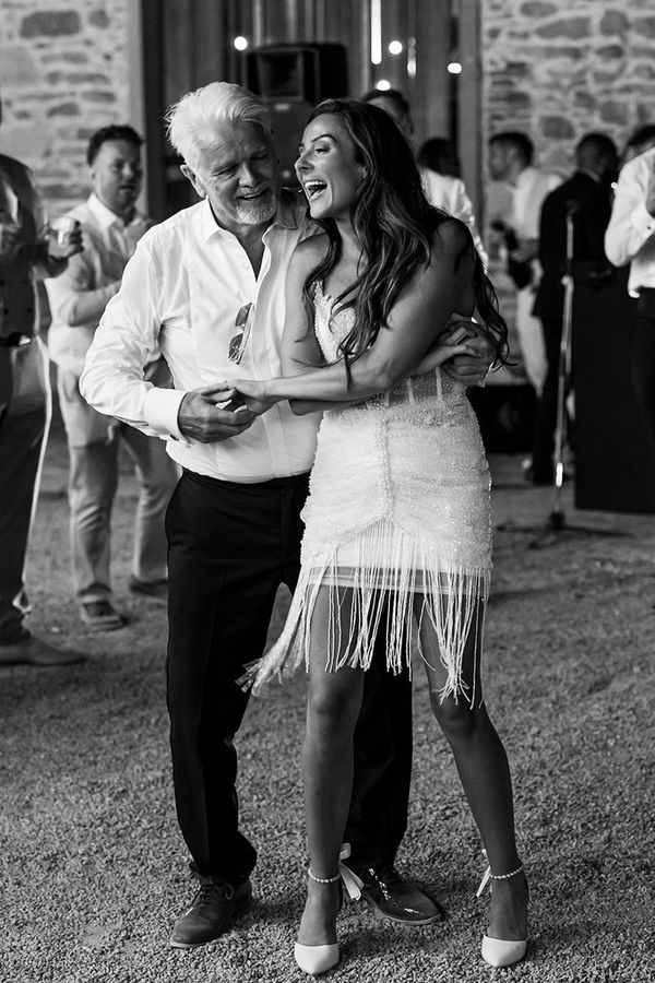 Bride dancing with the father of the bride in a white shirt